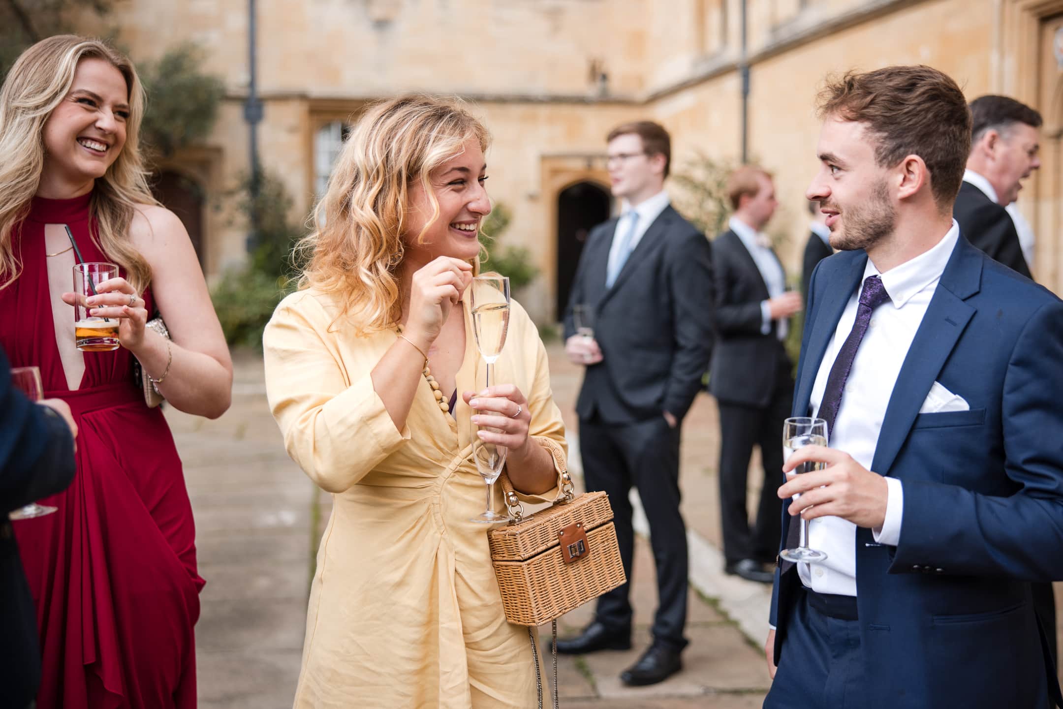 Guests enjoying Champagne reception in the Quad at Corpus Christi College Oxford Wedding