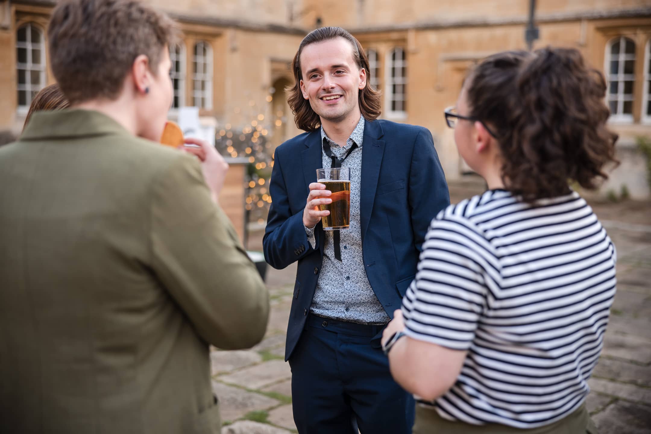 Guests talking in the Quad at Corpus Christi College Oxford