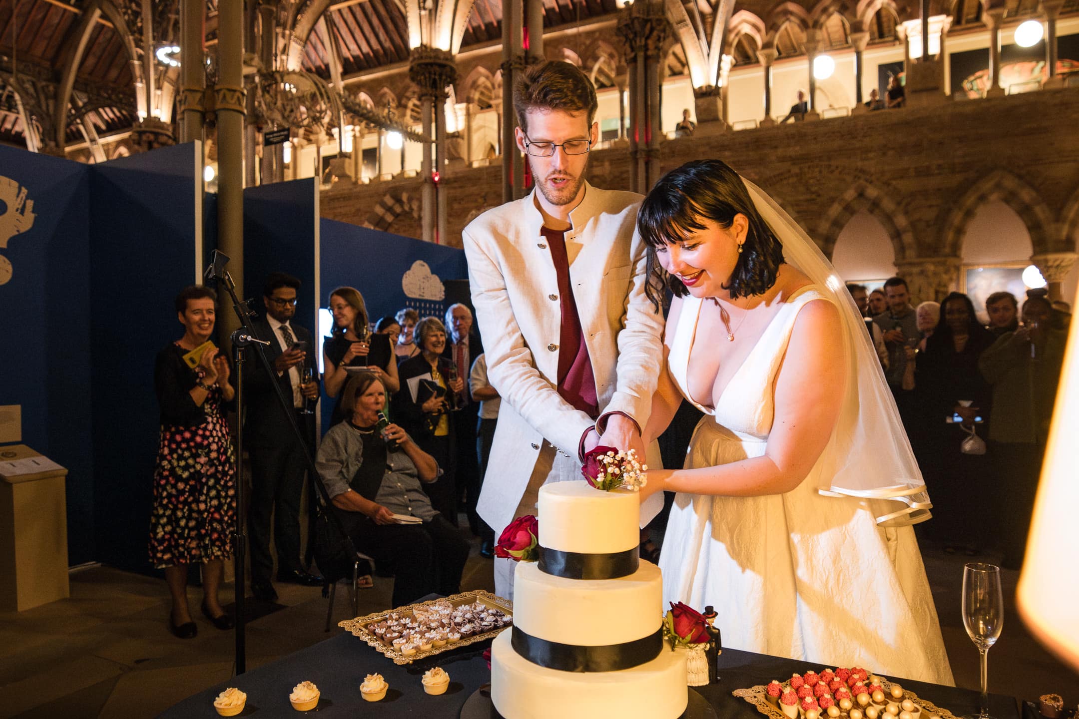 Cutting the cake at the Oxford Natural History Museum wedding reception