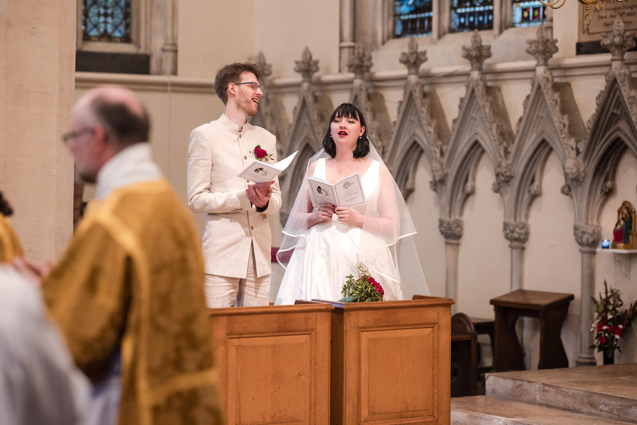 Bride and Groom at singing during wedding service at St Mary Magdalen Church Oxford