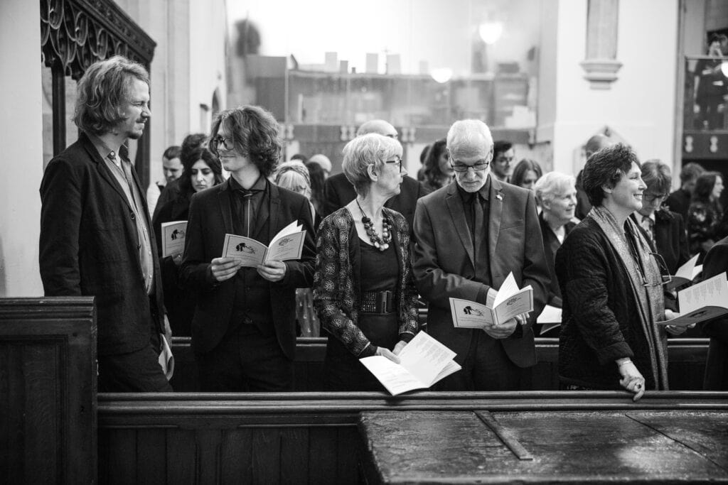 Guests reading the Service at St Mary Magdalen Church Oxford Wedding