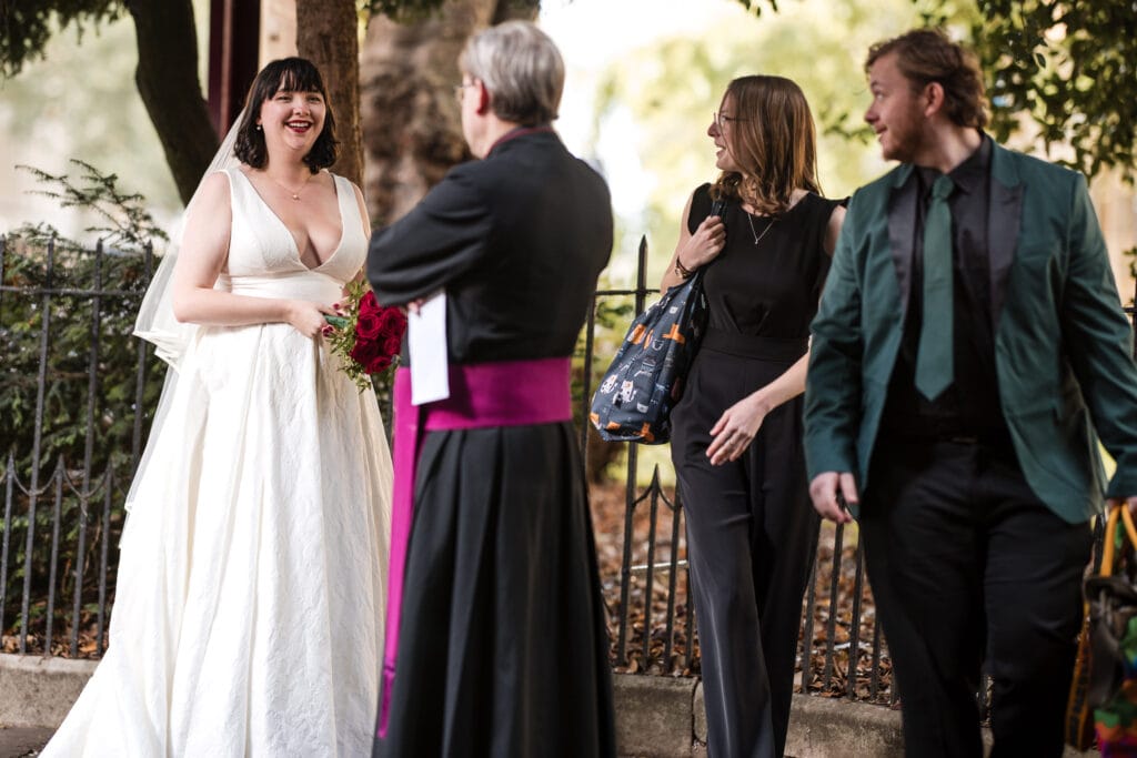 Bride talking to the Vicar prior to the Wedding Ceremony at St Mary Magdalen Church Oxford