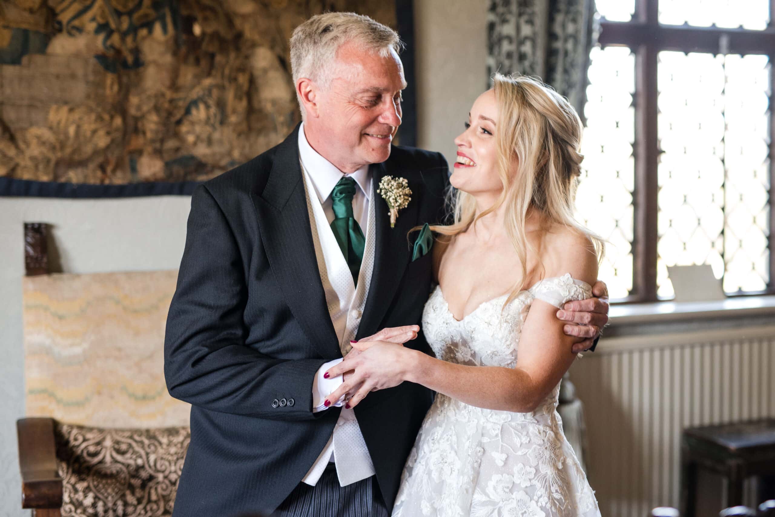 Chenies Manor Wedding father and bride cuddle.