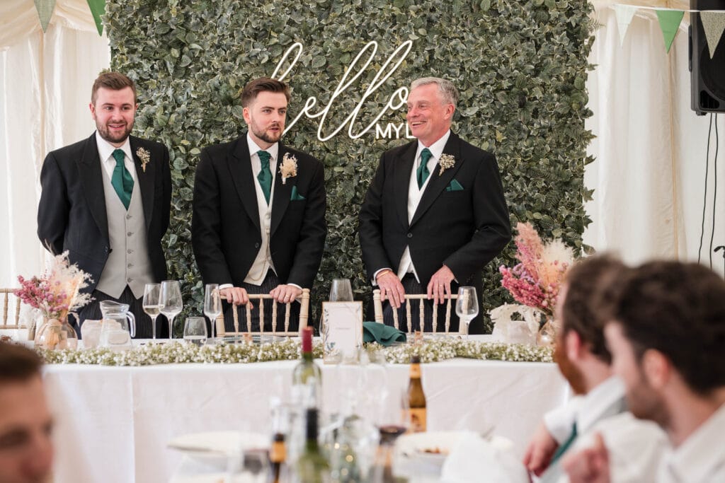 Father of the Bride talking to Groom and Best Man