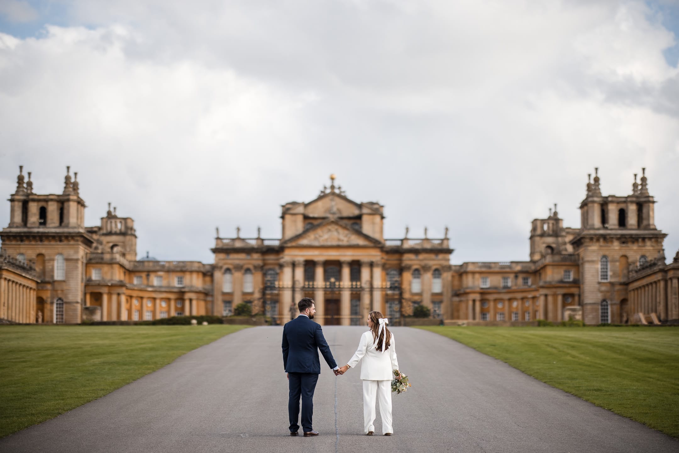 Bride and Groom looking on at Blenheim Palace Woodstock