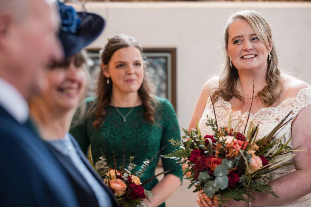 Bride looking on.