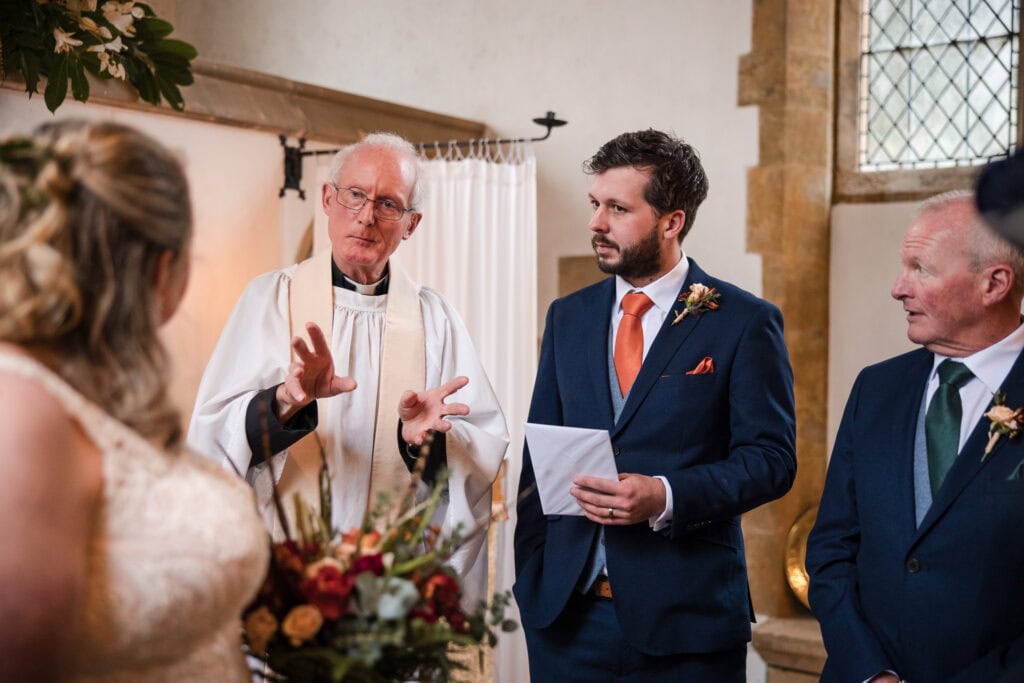 Vicar talking to bride and groom