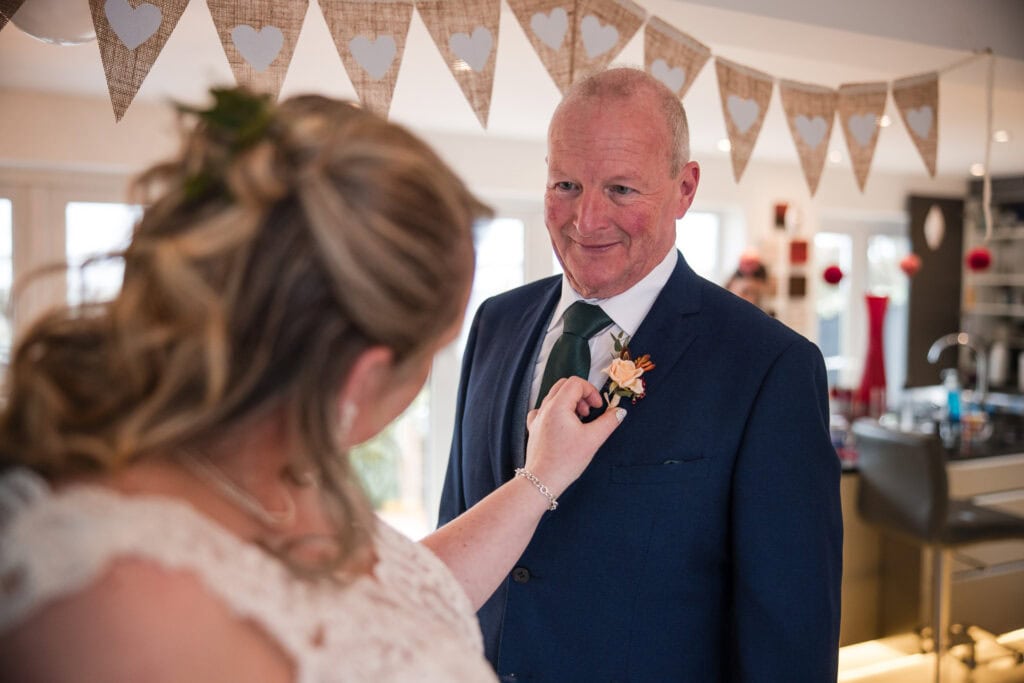 adjusting the father of the bride buttonhole