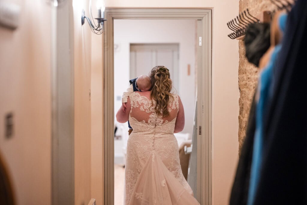 Baby sleeping on Brides Shoulder