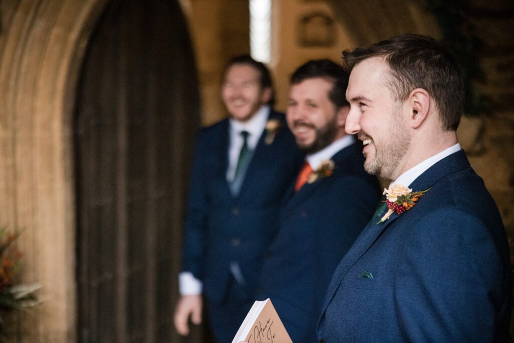 Best man, Groom and usher greating guests at church