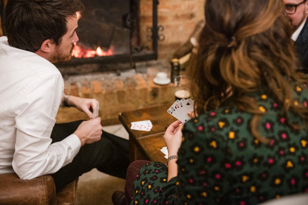 Wedding Guests enjoying a game of cards at The Great Barn Ayhno