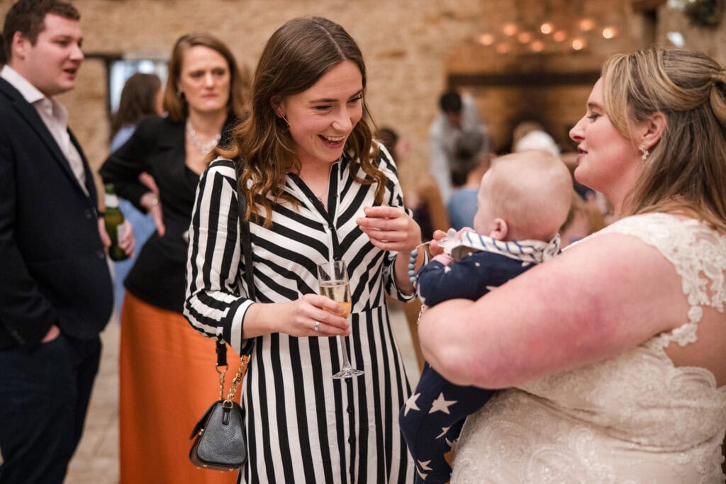 Bride and with baby introducing to guests