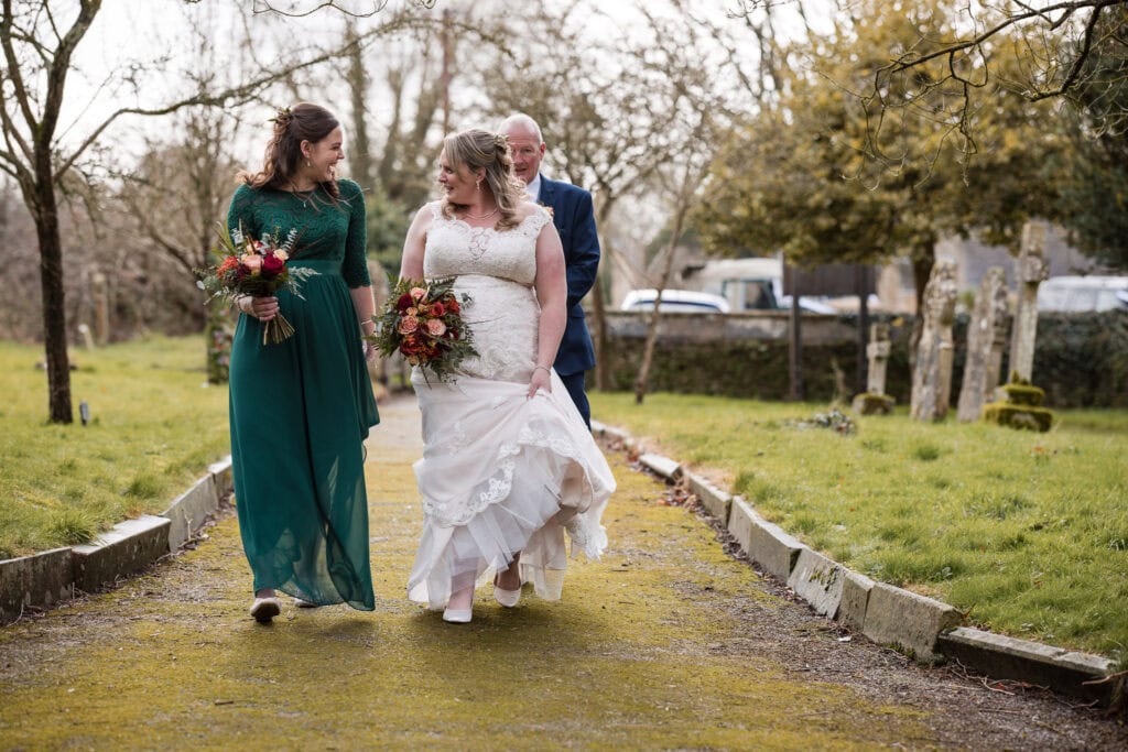 Bride and bridesmaid walking to the church