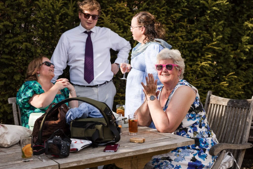 Guests sitting at table chatting whilst in the sun